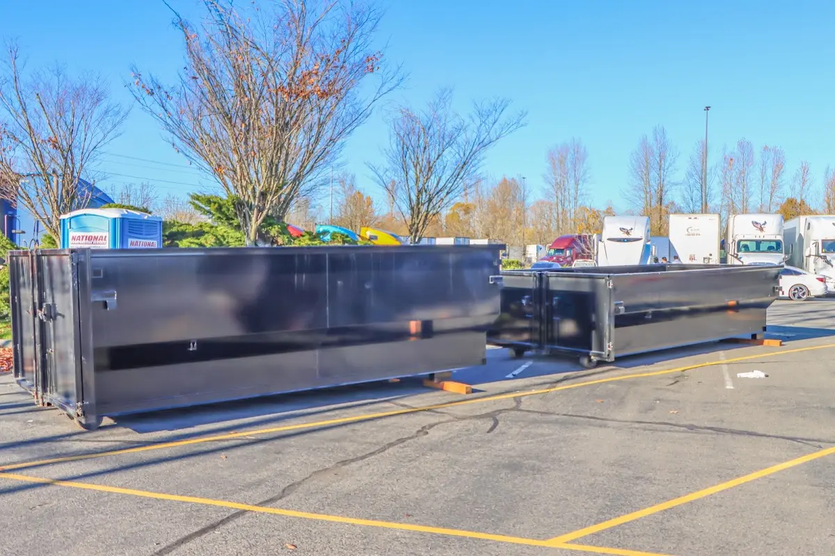 Professional dumpster rental service with roll-off container on residential driveway in Hastings-on-Hudson